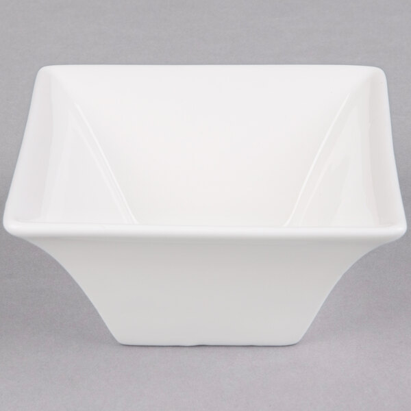 An Arcoroc white square flared bowl.
