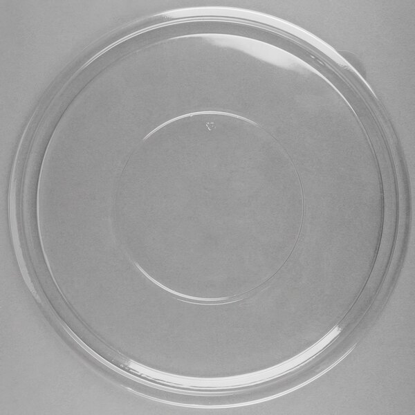A clear plastic lid with a circular rim on a white surface.