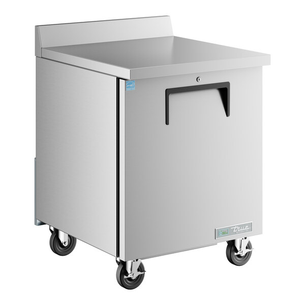 A silver True worktop refrigerator with wheels.