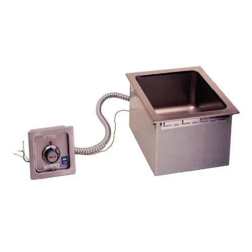 A Wells drop-in hot food well with thermostat control on a counter in a school kitchen.