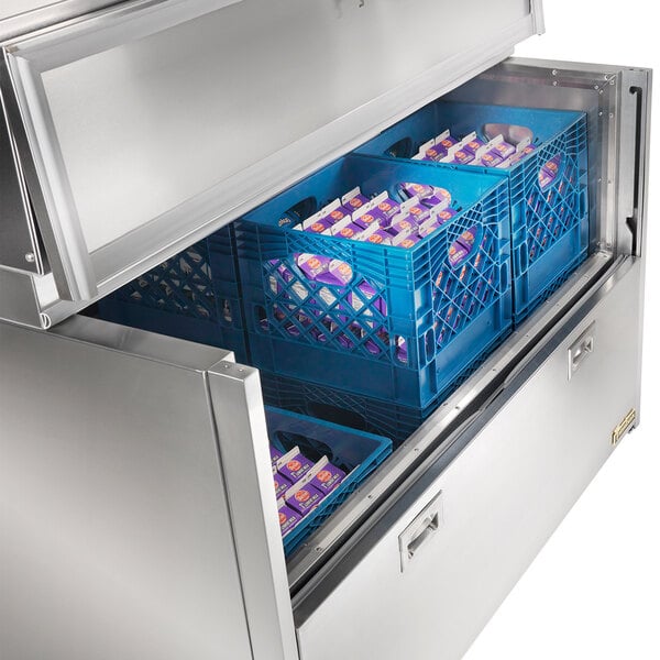 A Traulsen single sided school milk cooler with blue crates in it.