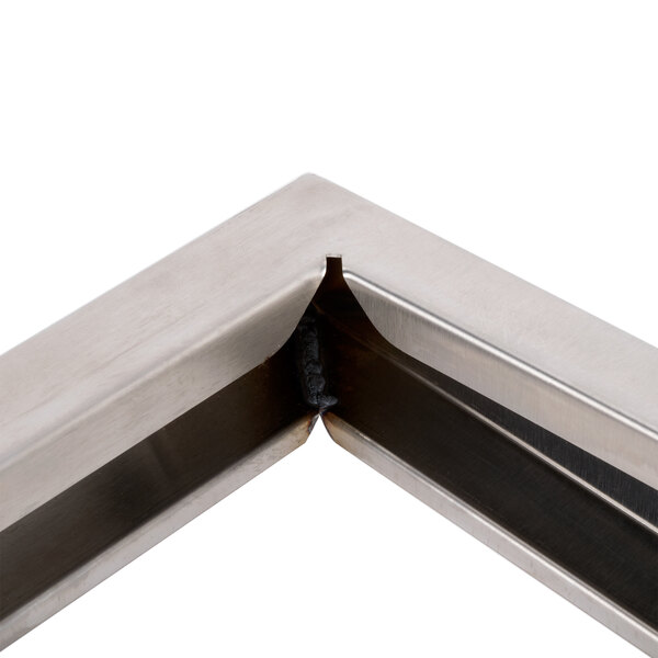 A metal corner piece with a hole in it.