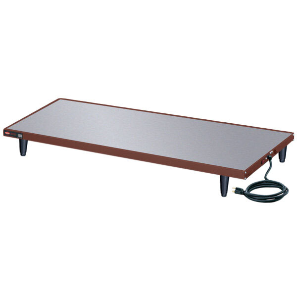 A rectangular Hatco heated shelf warmer on a table with a cord.