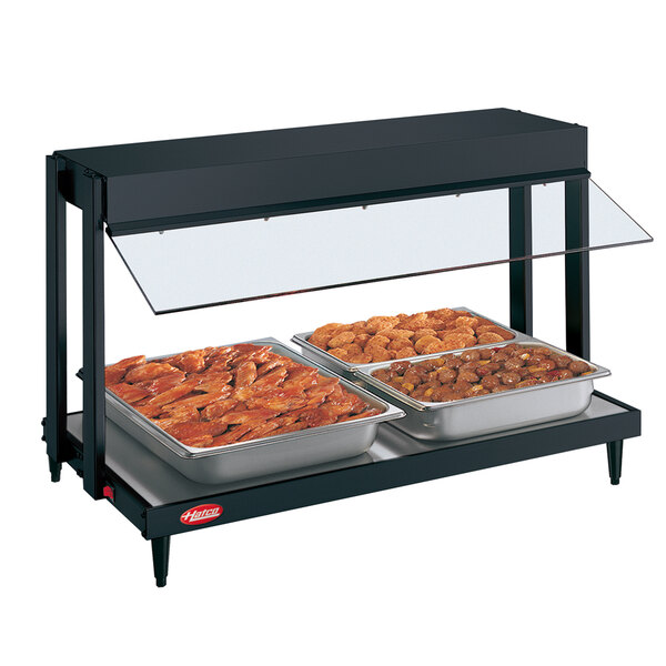 A black Hatco countertop food warmer with two trays of food in it.