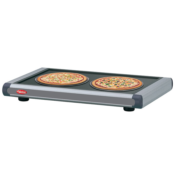 Hatco heated shelf with pizzas on a pan.