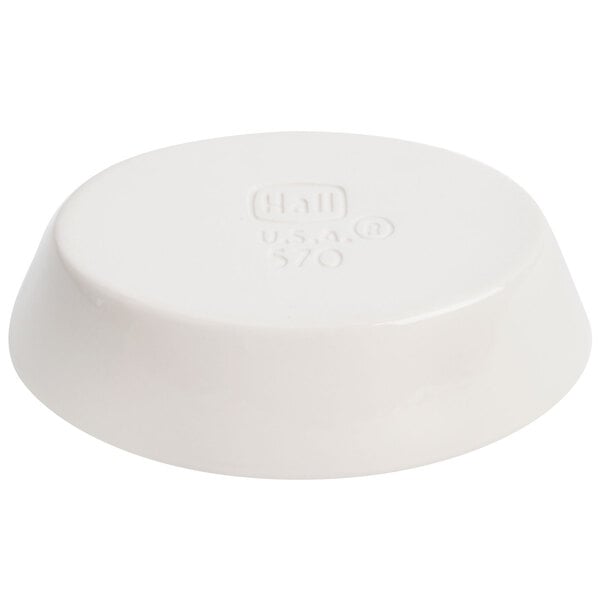 A white oval Hall China baker dish with text on it.