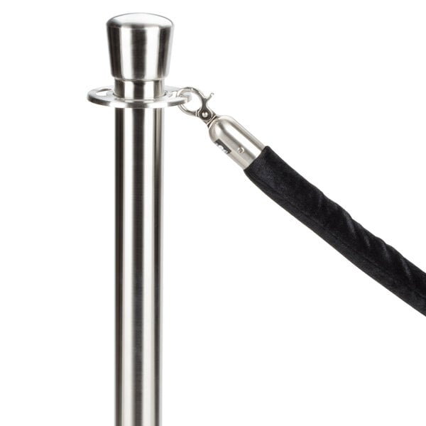 A black Aarco stanchion rope with satin ends attached to a metal pole.