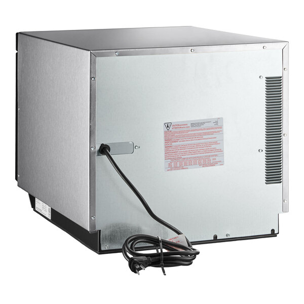 A silver stainless steel Amana commercial microwave with a black power cord.