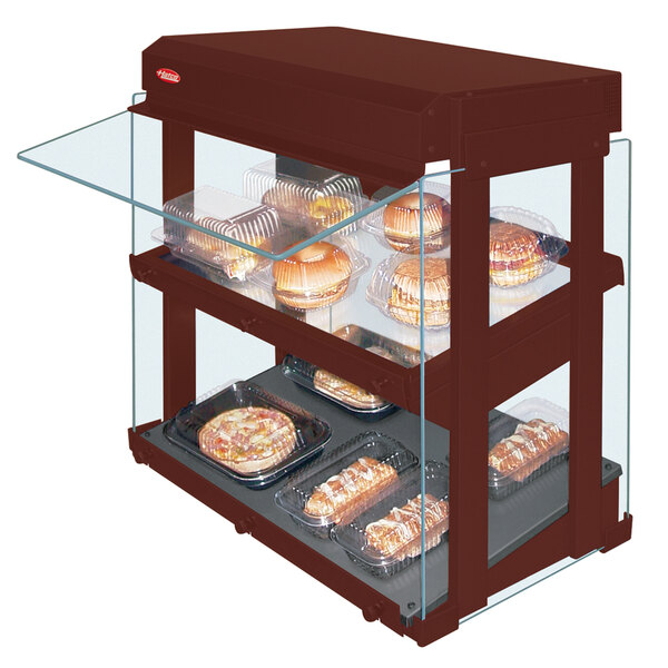 A Hatco countertop mini-merchandising warmer with slanted glass shelves holding food.