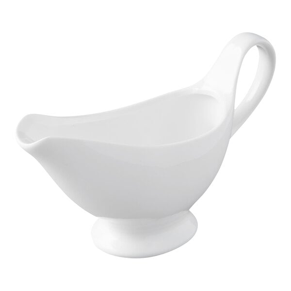 A white porcelain gravy boat with a handle and spout, shown on a plain background.