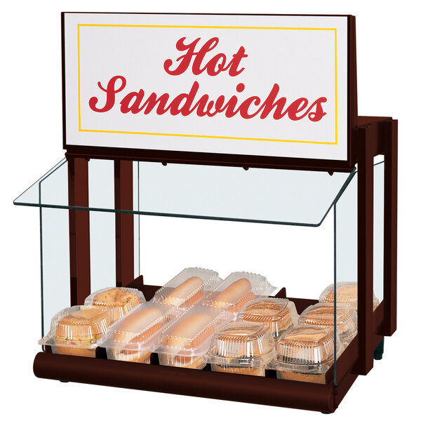 A Hatco countertop warmer with hot sandwiches in plastic containers.