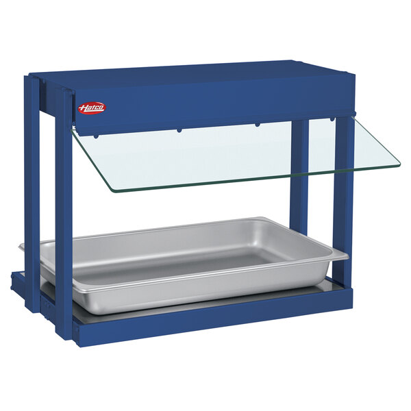 A blue Hatco mini-merchandising warmer with a metal shelf and glass tray on top.