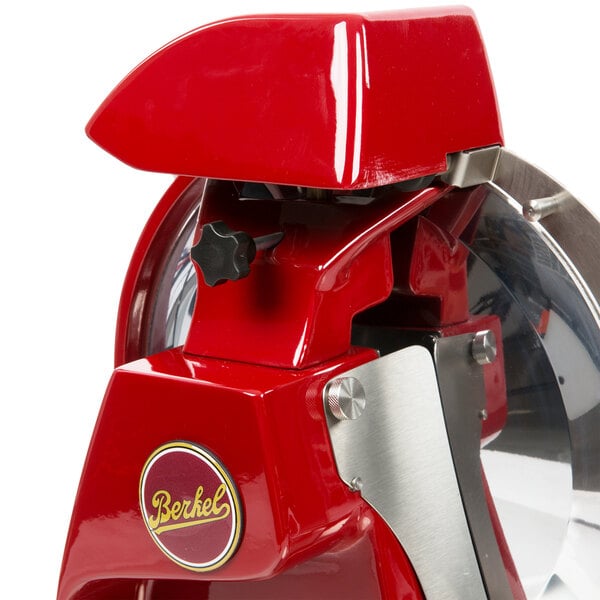 A red and silver Berkel 300M-STD Prosciutto meat slicer.