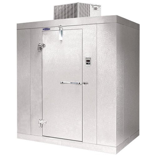 A white metal Norlake Kold Locker walk-in freezer with a door open.