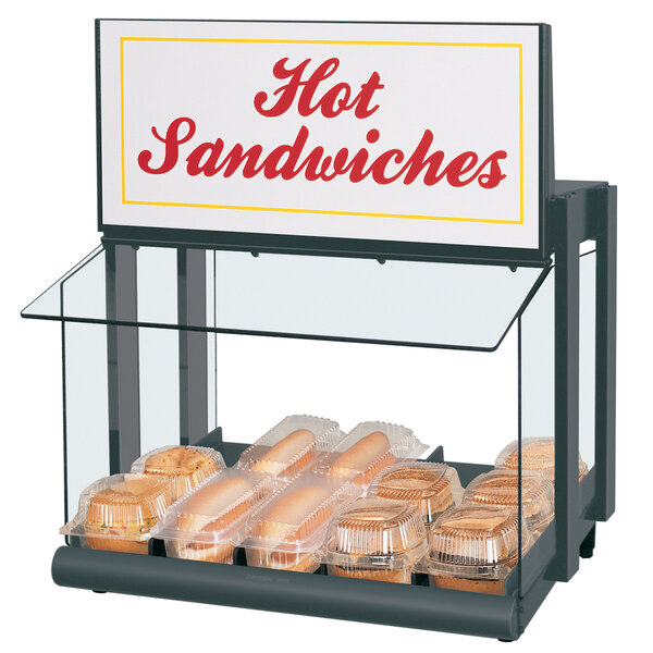 A Hatco mini-merchandising warmer with hot dogs and buns on a counter.