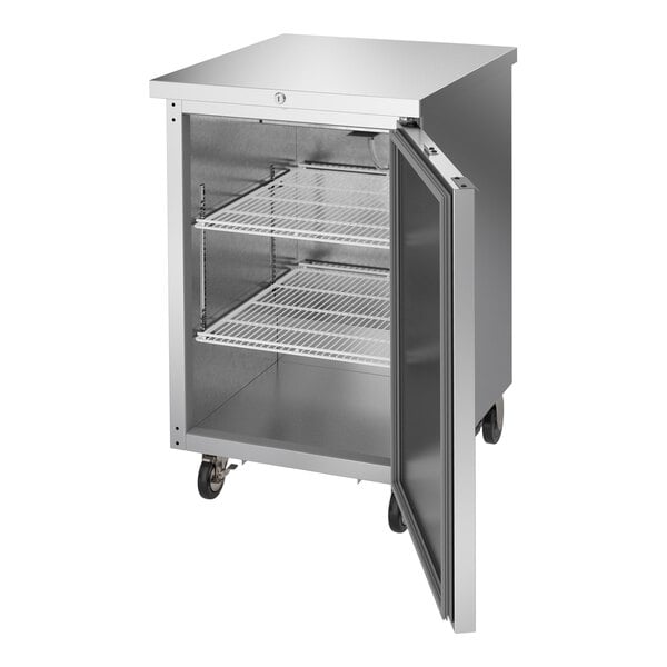 A stainless steel counter height back bar refrigerator with a solid door and wire shelves.