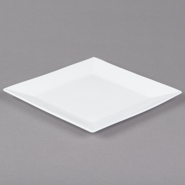 A white square porcelain platter with a white rim on a gray surface.