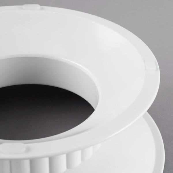 A white melamine pedestal with a circular hole on top.