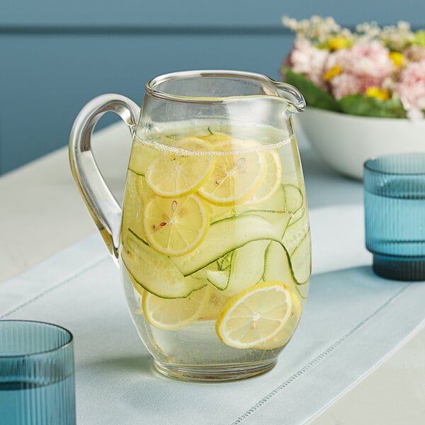 A Libbey glass pitcher filled with water, lemons, and cucumbers.