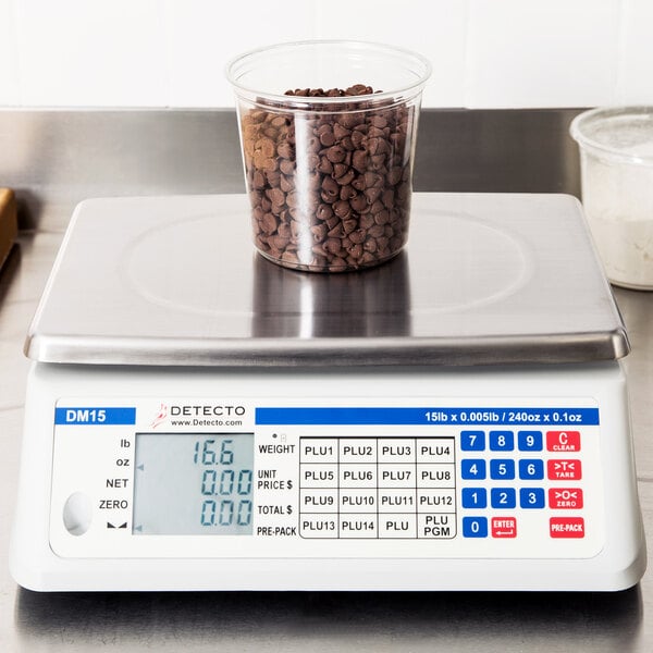 A Cardinal Detecto DM15 price computing scale weighing a container of chocolate chips.