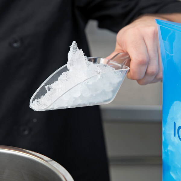 A person using a Cal-Mil Classic polycarbonate scoop to serve ice into a bowl.