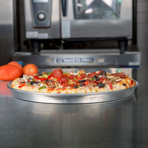 An American Metalcraft deep dish pizza on a metal tray.