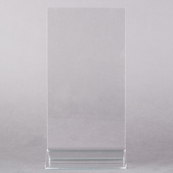 A clear plastic stand with a black border holding a white rectangular paper.