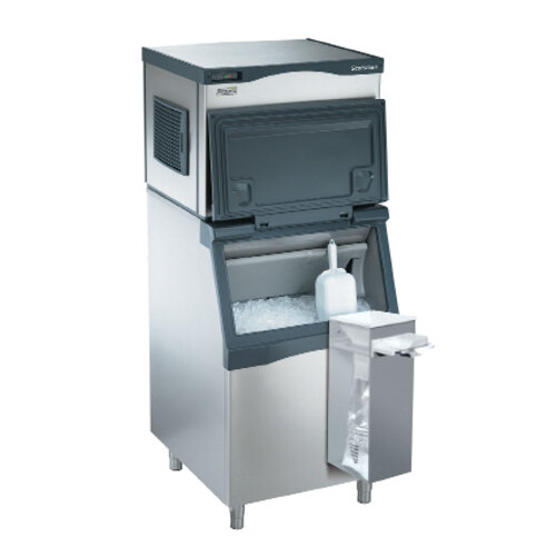 A Scotsman aluminum ice bagger kit on a counter with a bottle and ice cubes in it.
