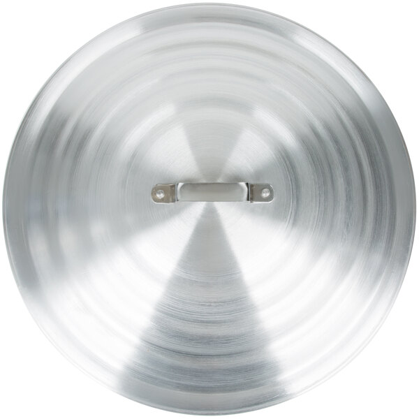 A close-up of a Town aluminum steamer lid with a hole in the center.