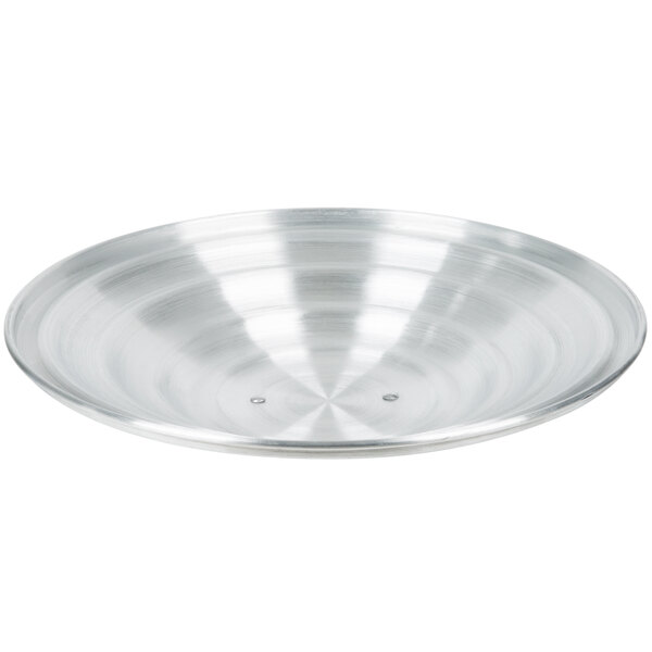 An aluminum steamer cover with a metal surface and a circular pattern.