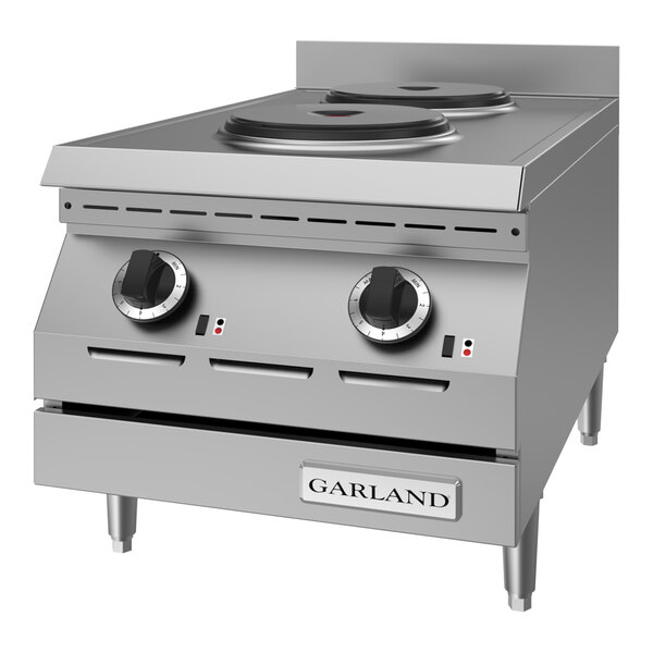 A stainless steel electric countertop hot plate with two solid burners and control knobs, designed for commercial use.