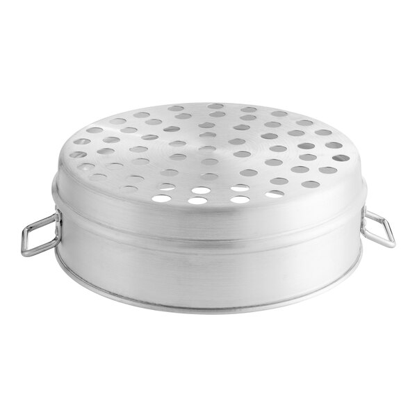 A silver metal circular surface with holes.