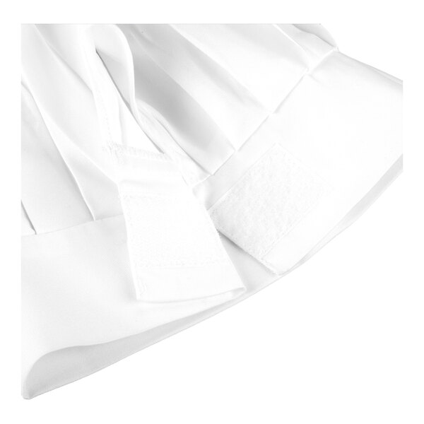 A close-up of a white fabric item with pleats and an adjustable Velcro strap.