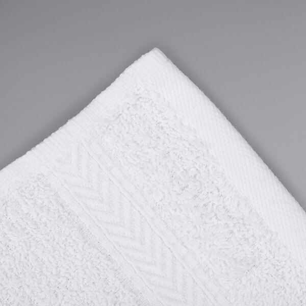 A white Oxford Gold dobby wash cloth with a pattern on it.