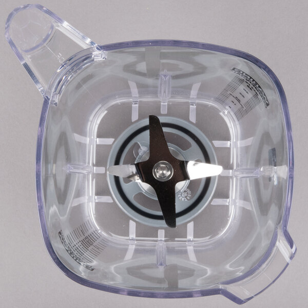 The clear plastic container for a Waring Raptor blender with a blade inside.