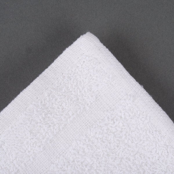 An Oxford Bronze white wash cloth with a textured edge.