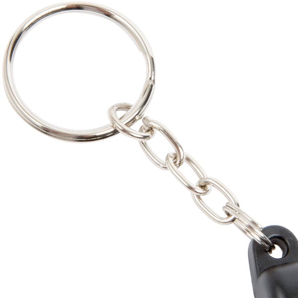 A Turn-O-Matic wireless remote replacement with a black and silver key chain.
