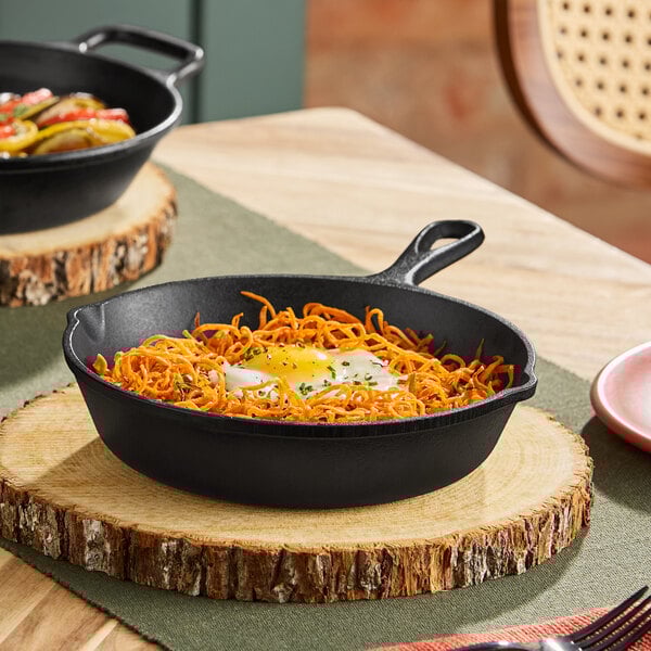 An 8-inch pre-seasoned cast iron skillet with a handle, shown on a wooden serving board.