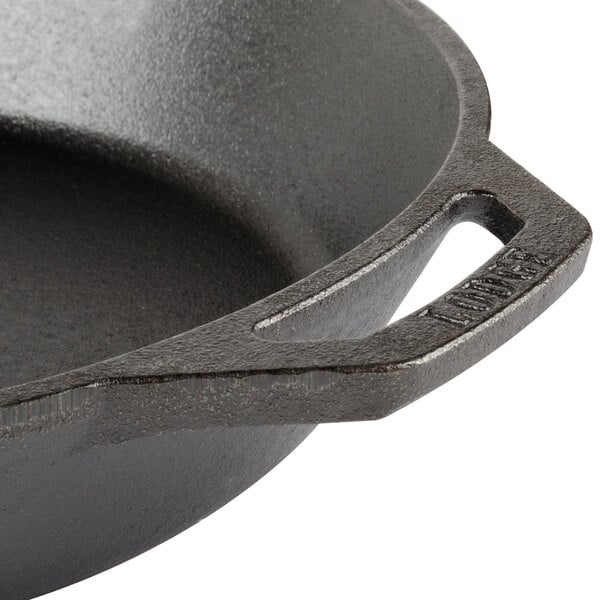 A Lodge pre-seasoned cast iron skillet with a helper handle.