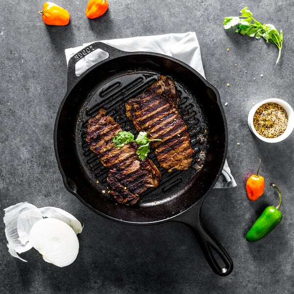 Cast iron grill pan with grilled meat inside