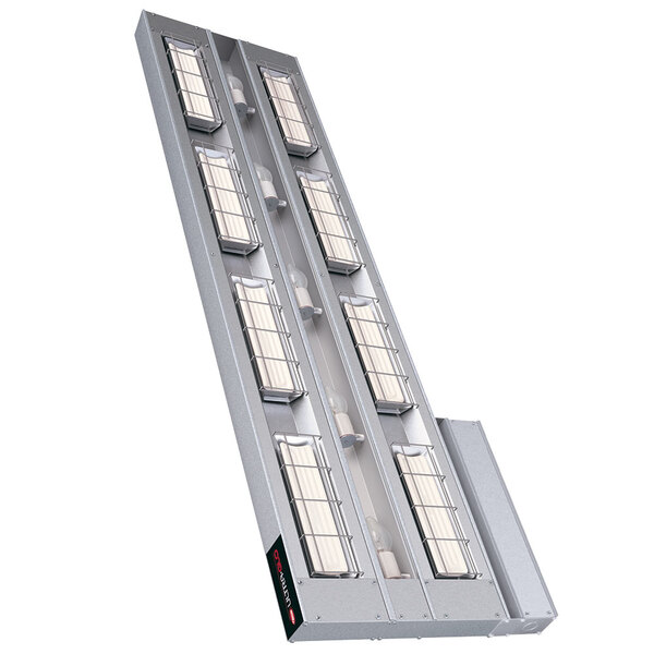 A long rectangular metal light fixture with many windows containing four lights.