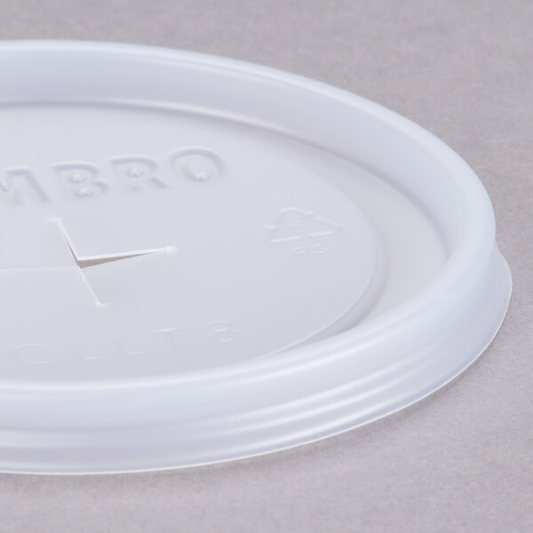 A white plastic Cambro lid with a straw slot.