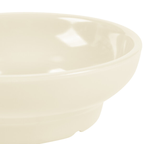 An ivory melamine salsa dish with a white rim.