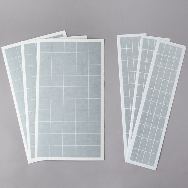 Curtron insect trap glue boards with white rectangular papers and white squares.