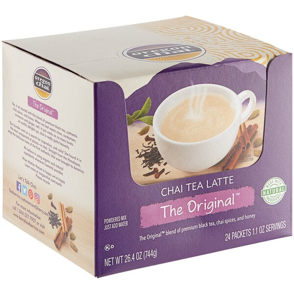 A box of 24 Oregon Chai single serve packets with a cup of hot chai tea.