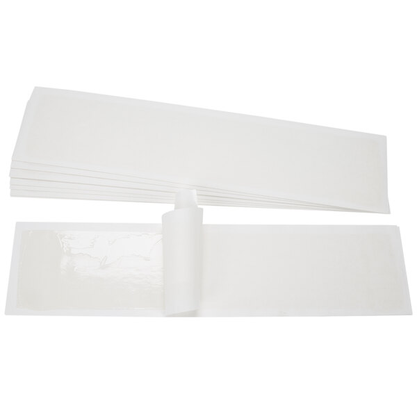 A stack of white rectangular paper strips.
