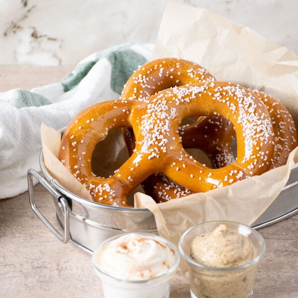 A Regal metal bowl of pretzels with salt.
