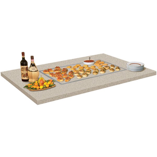 A table with a Hatco Glo-Ray heated stone warmer shelf holding food on it.