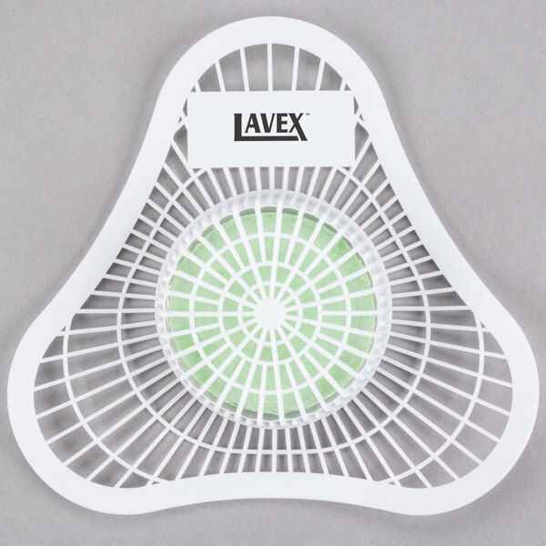 A white plastic Lavex urinal screen with a green and white circle in a white mesh basket.