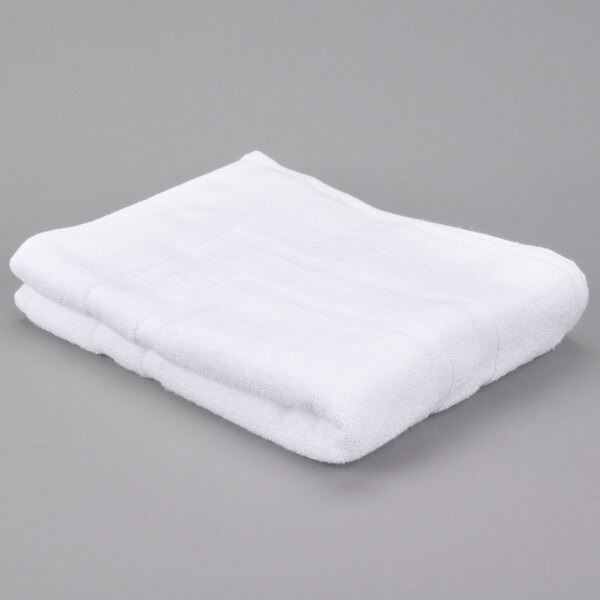 A white Oxford Miasma bath mat on a gray surface.